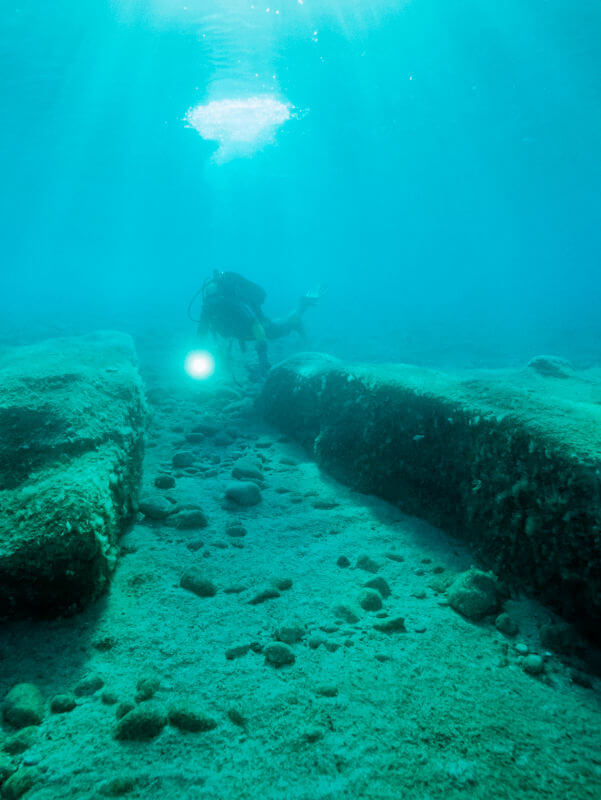 Archaeological diver in shallow water